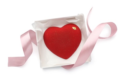 Heart shaped chocolate in box and pink ribbon isolated on white, top view