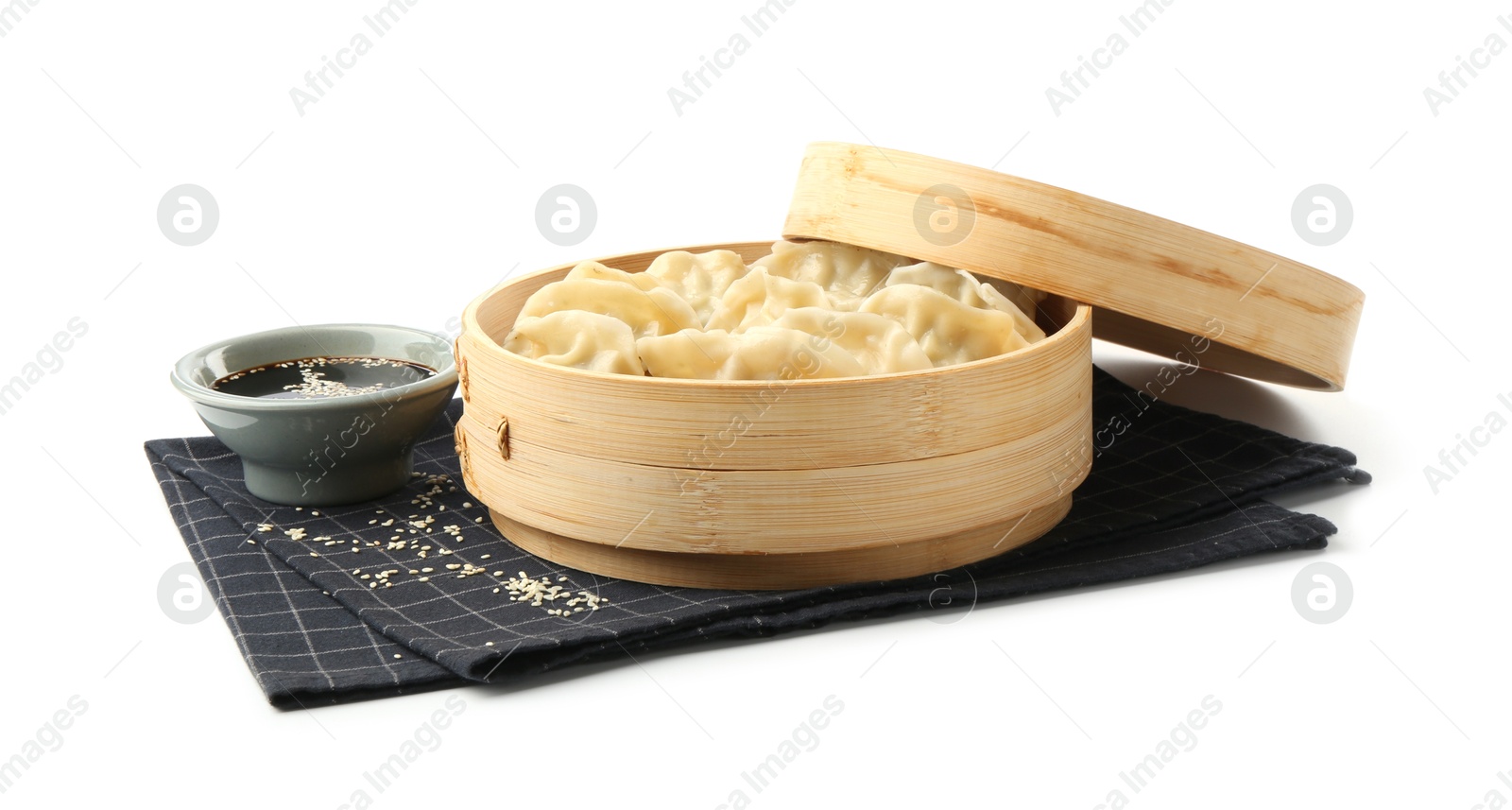 Photo of Tasty boiled gyoza (dumplings) with soy sauce and sesame on white background