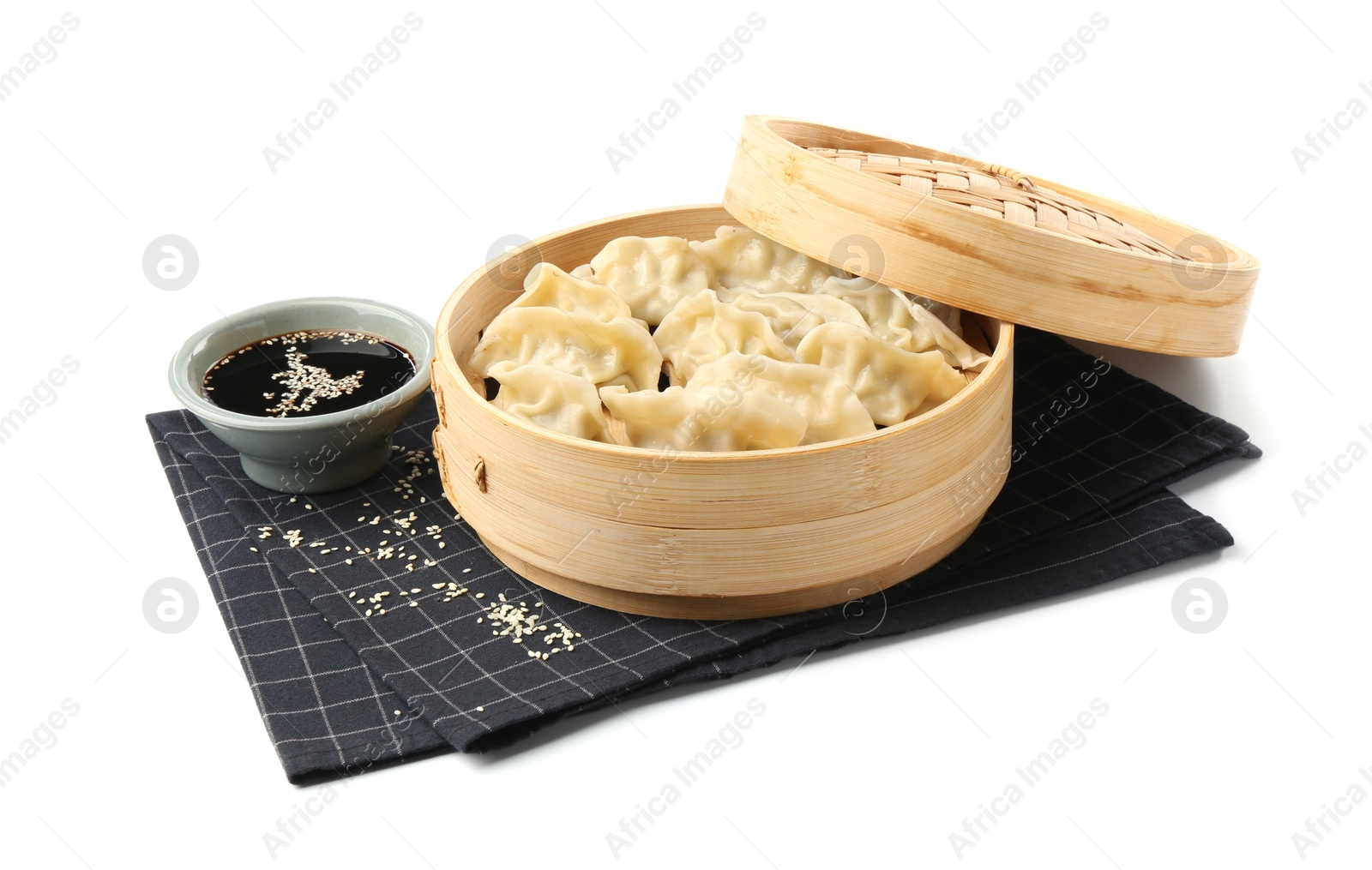 Photo of Tasty boiled gyoza (dumplings) with soy sauce and sesame on white background