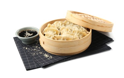 Photo of Tasty boiled gyoza (dumplings) with soy sauce and sesame on white background