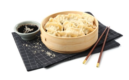 Photo of Tasty boiled gyoza (dumplings) with soy sauce, chopsticks and sesame on white background