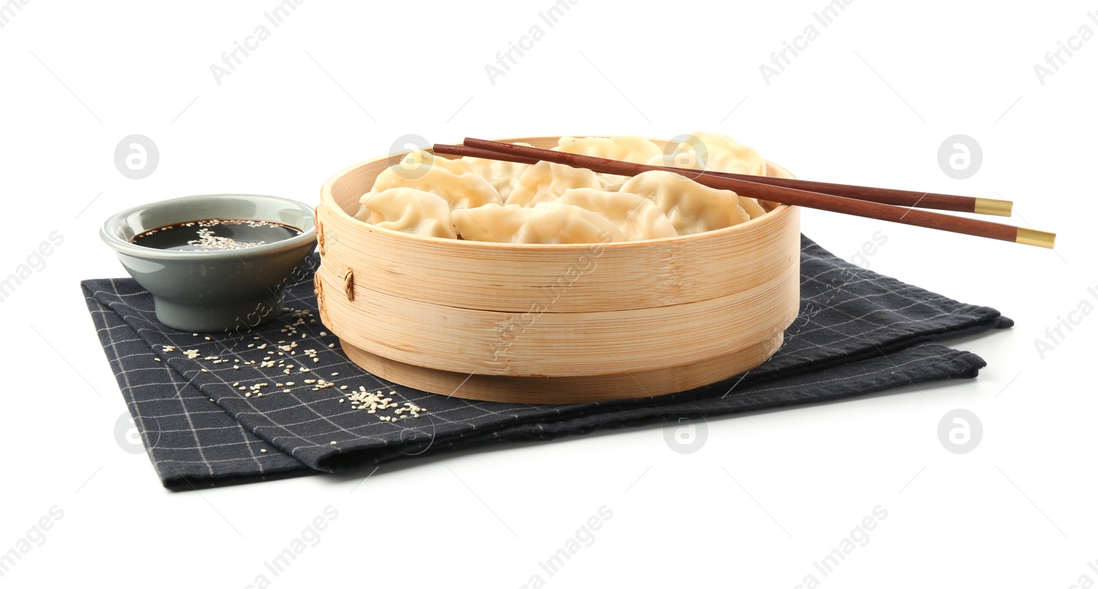 Photo of Tasty boiled gyoza (dumplings) with soy sauce, chopsticks and sesame on white background