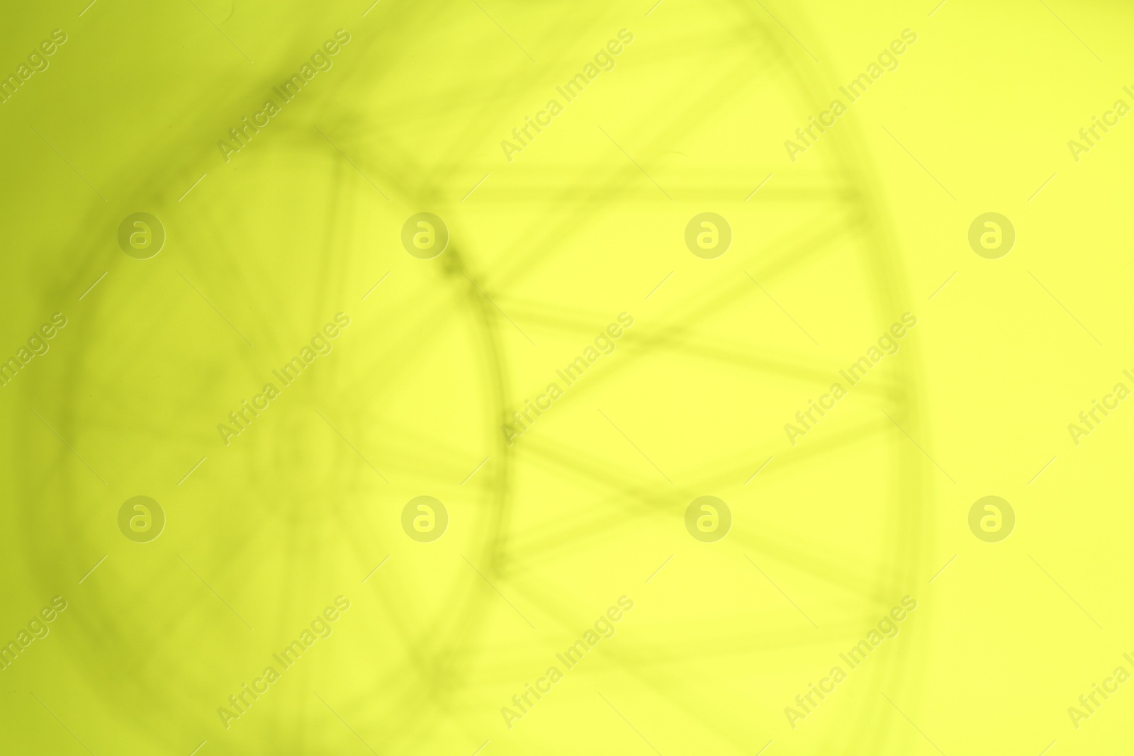 Photo of Light and shadows falling on light green background