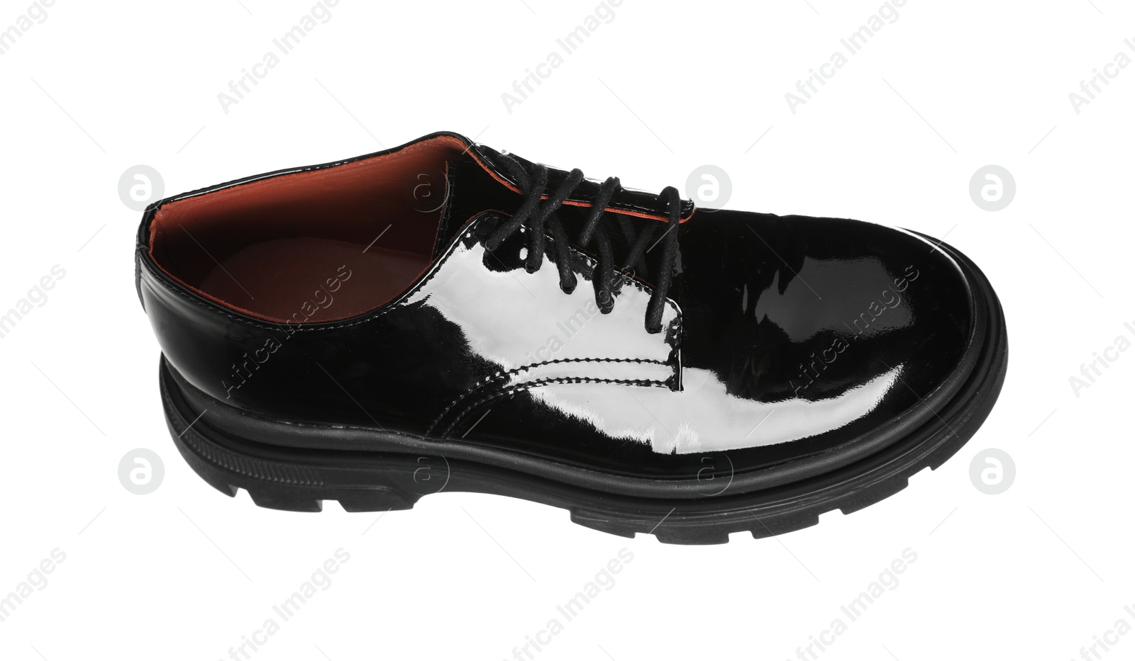 Photo of One black leather shoe in air isolated on white