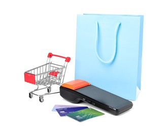 Photo of Payment terminal, shopping bag, credit cards and mini cart isolated on white