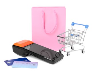 Photo of Payment terminal, shopping bag, credit cards and mini cart isolated on white