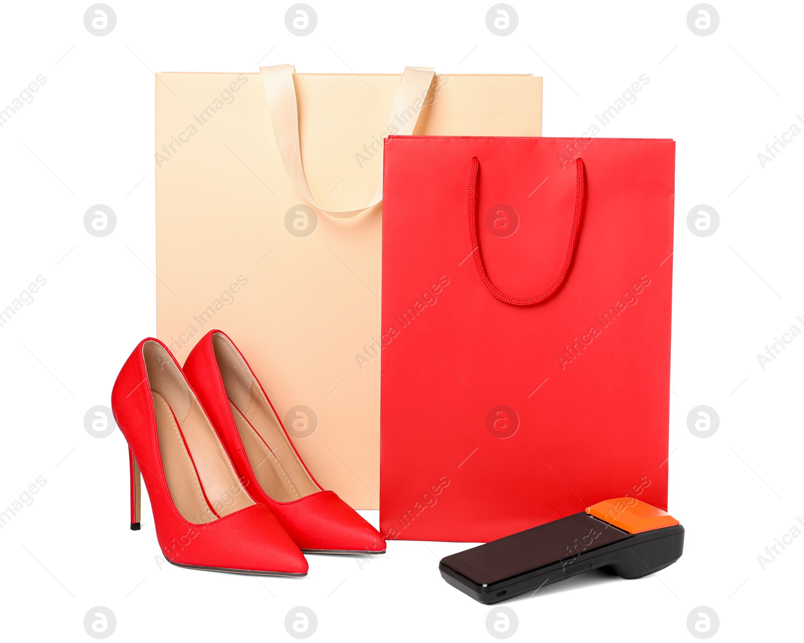 Payment terminal, shopping bags and heels isolated on white Photo of Payment terminal, shopping bags and heels isolated on white
