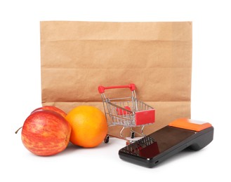 Photo of Payment terminal, shopping bag, fruits and mini cart isolated on white