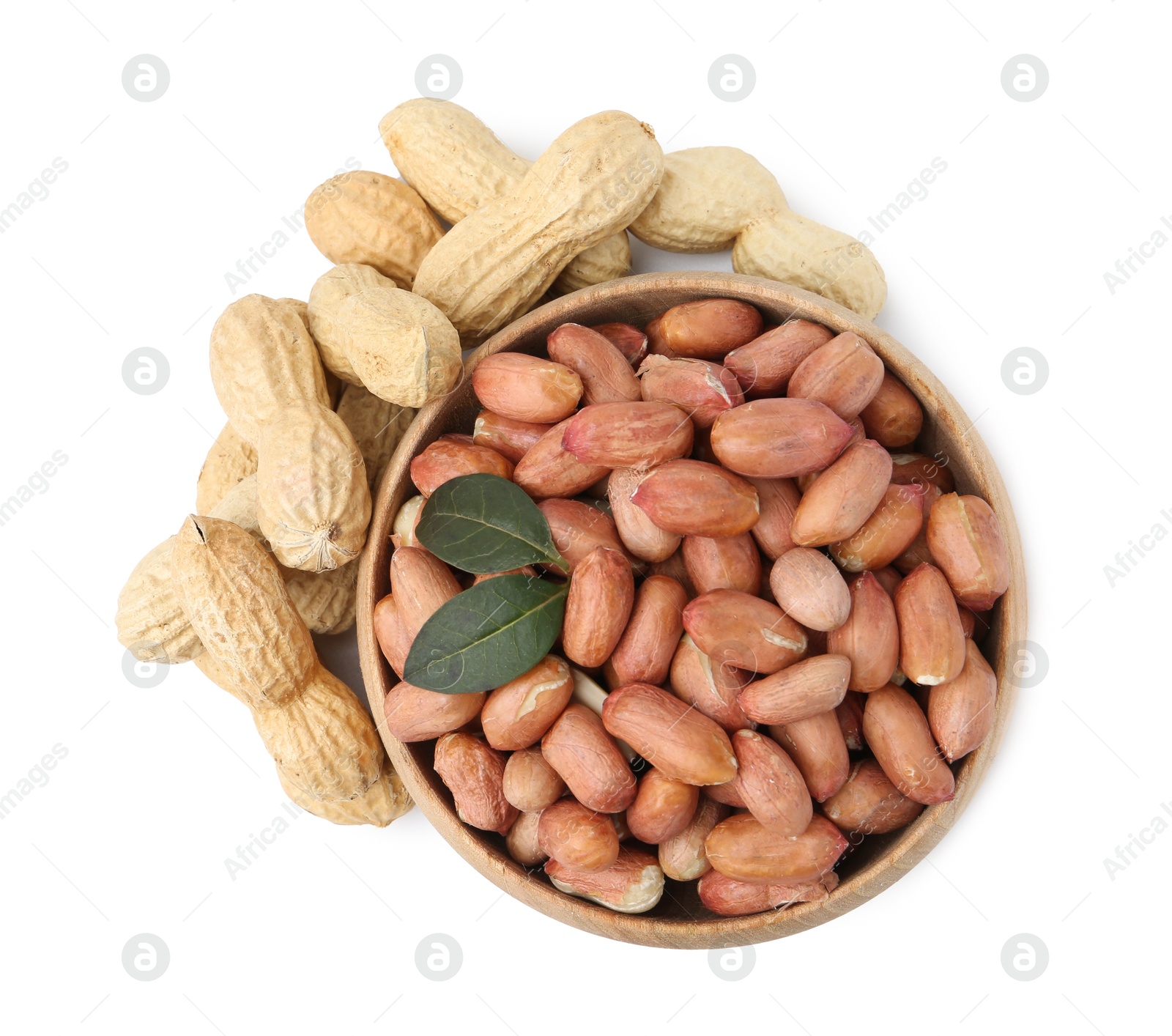 Fresh peanuts and bowl isolated on white, top view Photo of Fresh peanuts and bowl isolated on white, top view