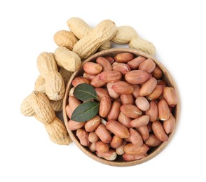 Photo of Fresh peanuts and bowl isolated on white, top view