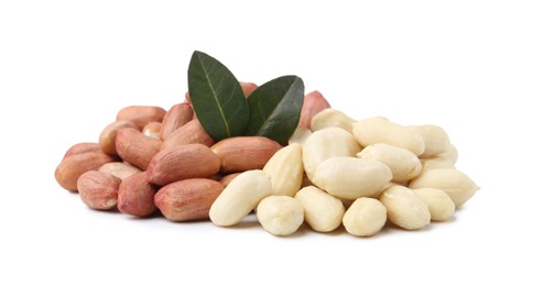 Photo of Pile of fresh peanuts and leaves isolated on white