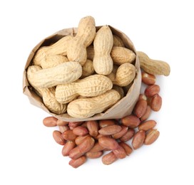 Photo of Fresh peanuts and paper bag isolated on white, top view