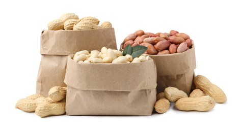 Photo of Different peanuts in paper bags isolated on white