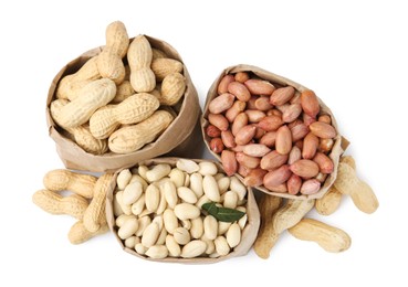 Photo of Different peanuts in paper bags isolated on white, top view