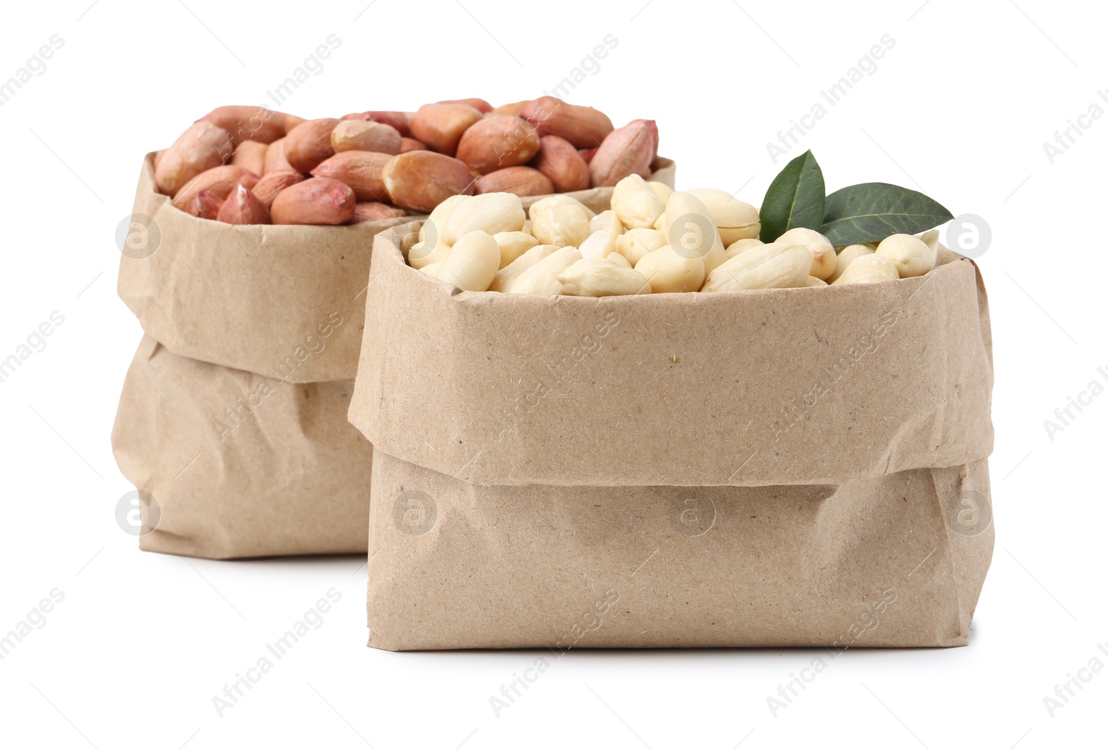 Fresh peanuts in paper bags isolated on white Photo of Fresh peanuts in paper bags isolated on white