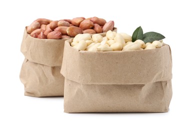 Photo of Fresh peanuts in paper bags isolated on white