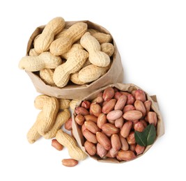 Photo of Fresh peanuts in paper bags isolated on white, top view