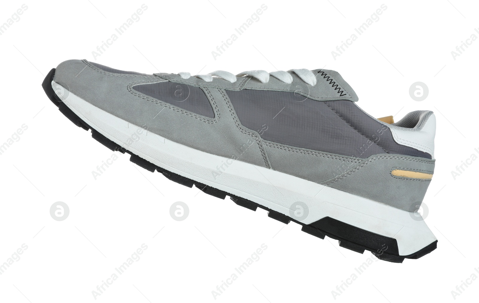 Photo of One grey sneaker in air isolated on white