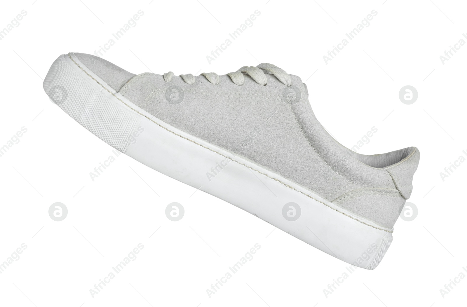 Photo of One grey sneaker in air isolated on white