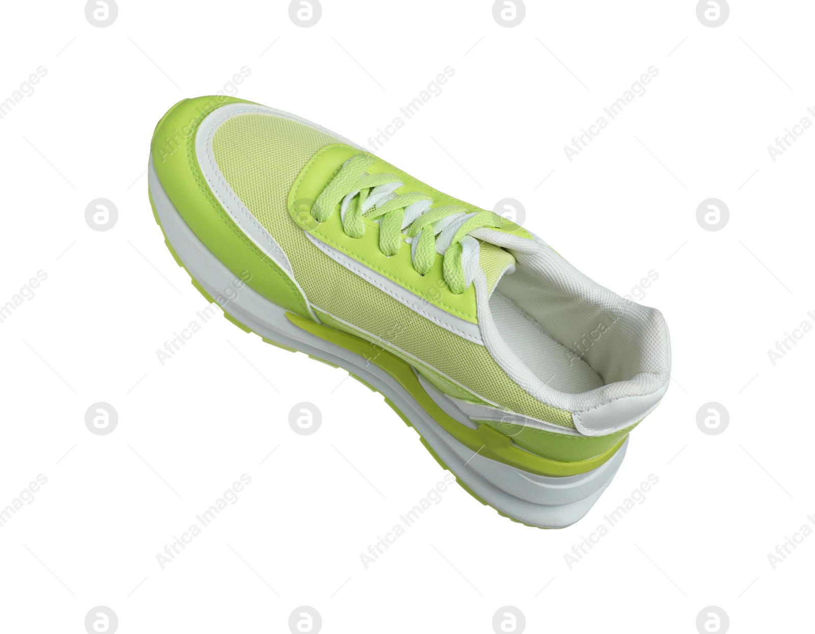 Photo of One green sneaker in air isolated on white