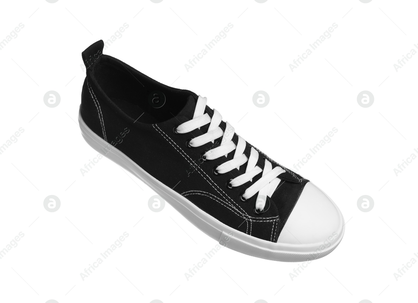 Photo of One black sneaker in air isolated on white