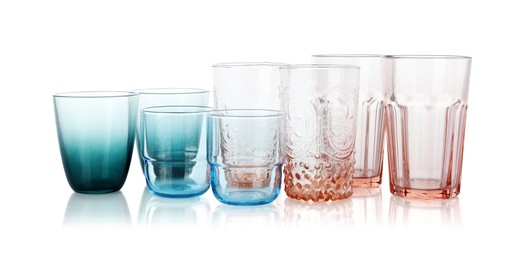 Photo of Many empty clean glasses isolated on white