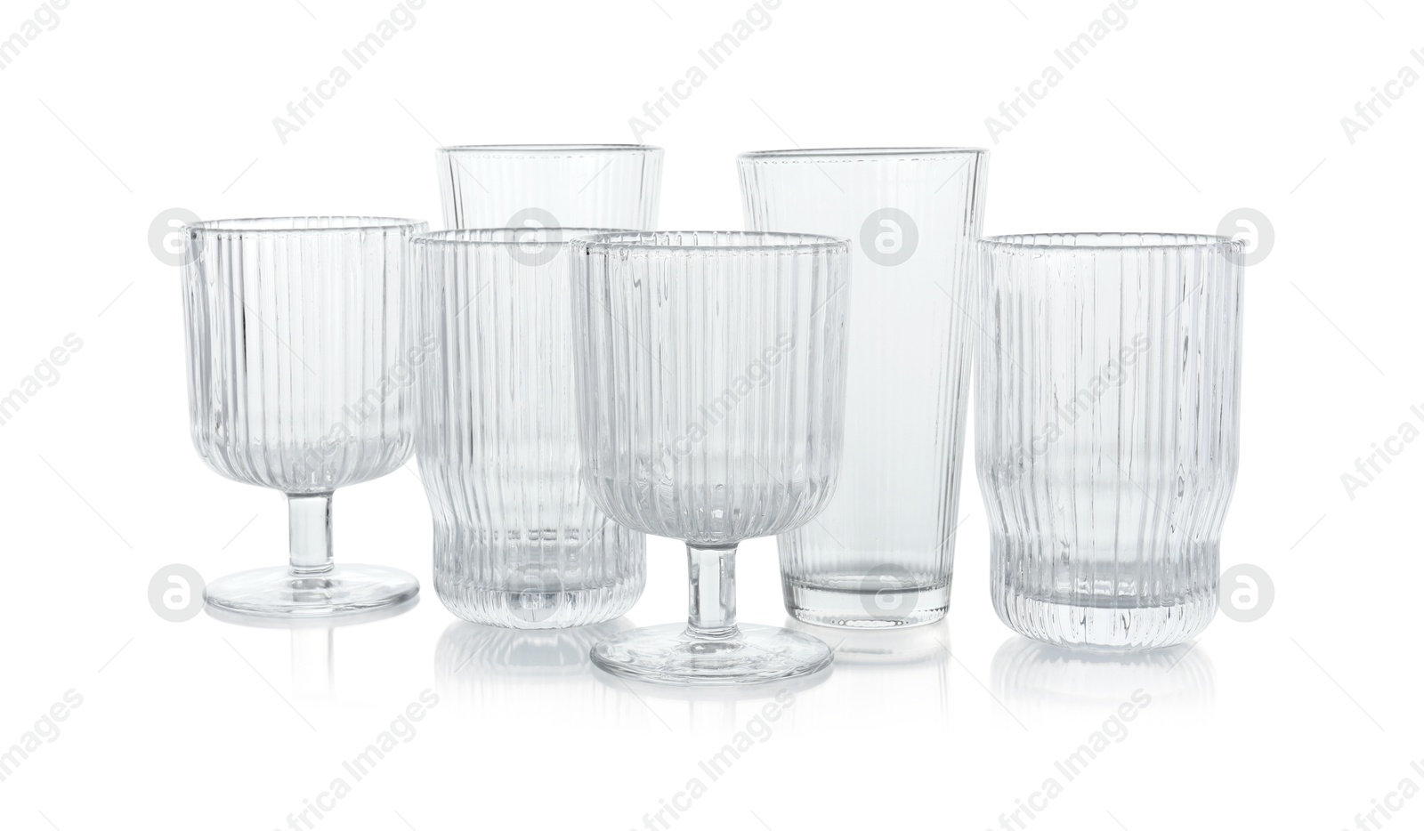 Photo of Many empty clean glasses isolated on white