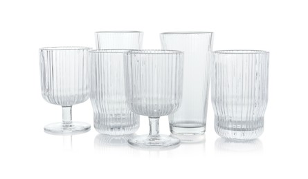 Photo of Many empty clean glasses isolated on white