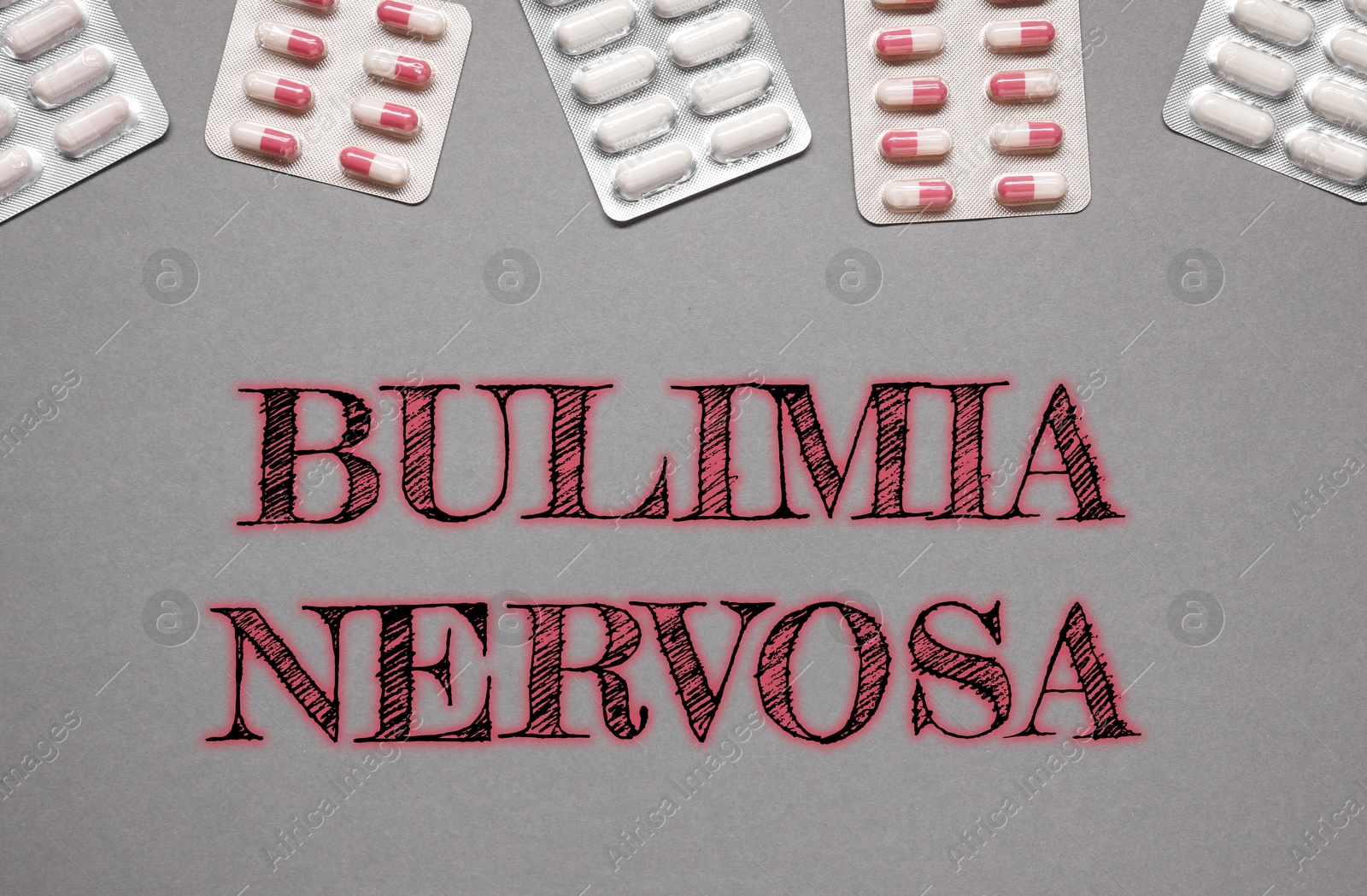 Image of Bulimia nervosa. Different pills in blisters on grey background, flat lay