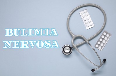 Image of Bulimia nervosa. Stethoscope and pills on grey background, flat lay