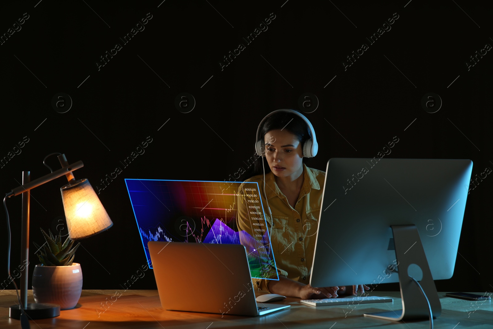 Image of Trading. Business woman working on laptop at night. Virtual screen with data and graph over computer