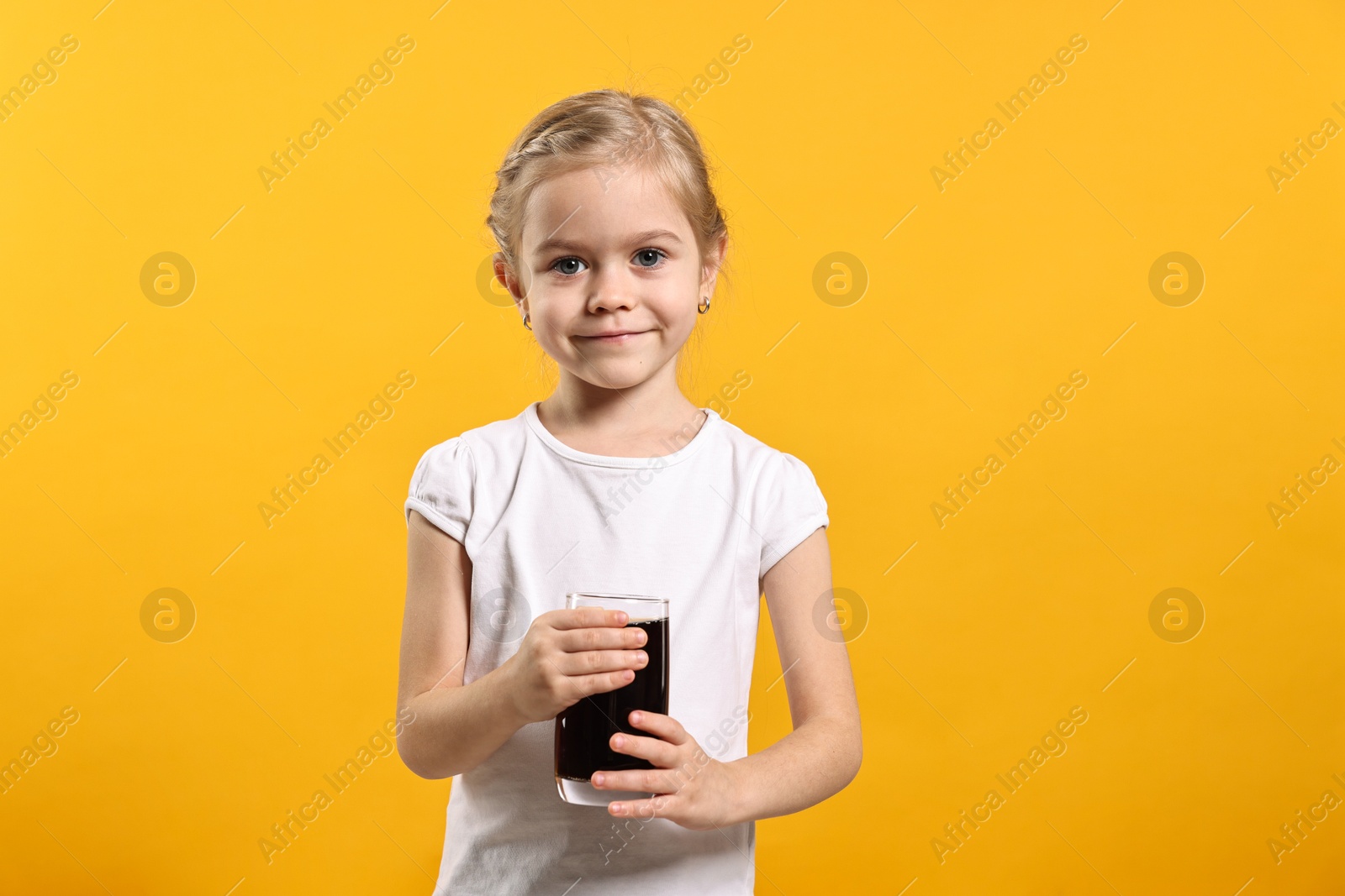 Photo of Girl with glass of refreshing soda drink on orange background