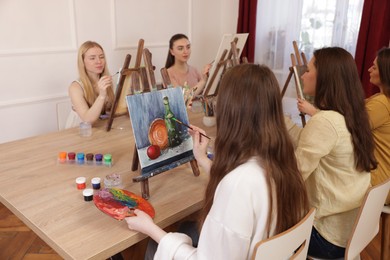 Photo of Group of women learning to draw at table in class