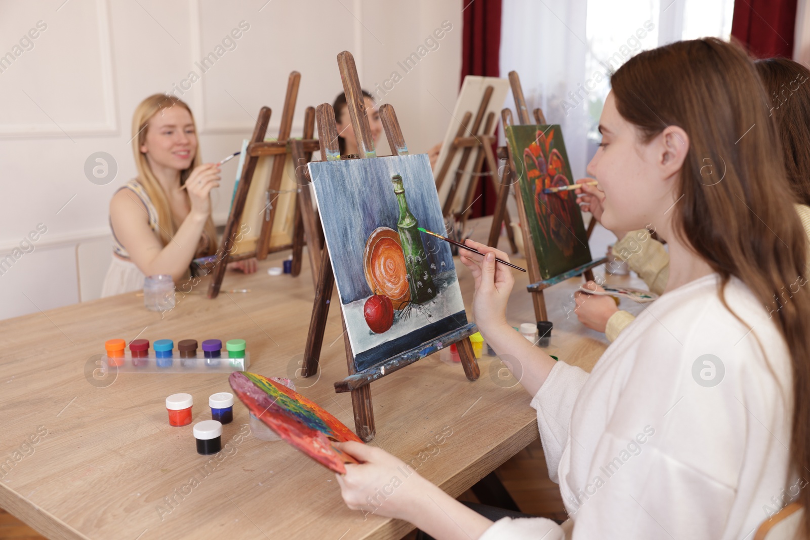 Photo of Group of women learning to draw at table in class