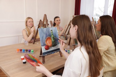 Photo of Group of women learning to draw at table in class