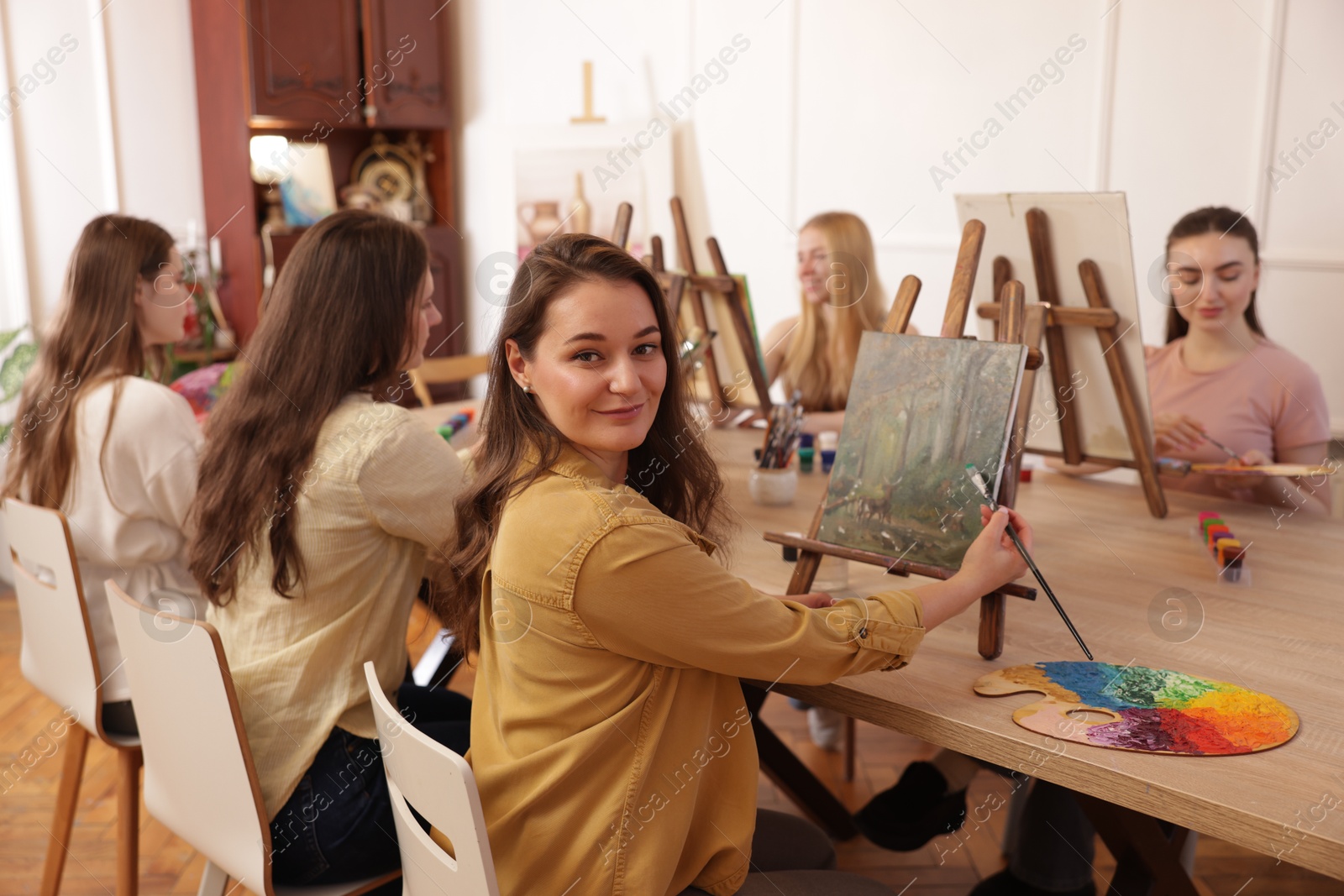 Photo of Group of women learning to draw at table in class