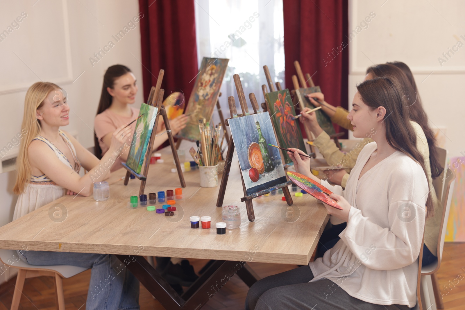 Photo of Group of women learning to draw at table in class