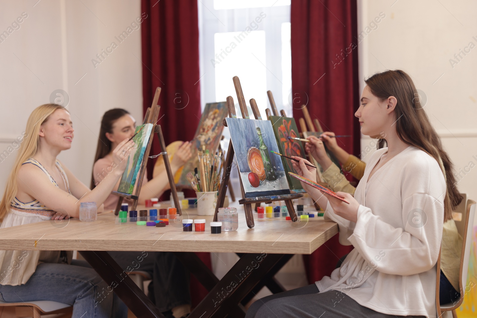 Photo of Group of women learning to draw at table in class