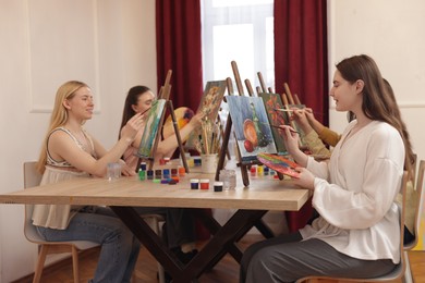 Photo of Group of women learning to draw at table in class