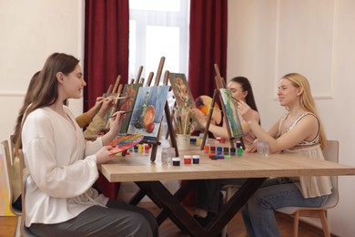 Photo of Group of women learning to draw at table in class