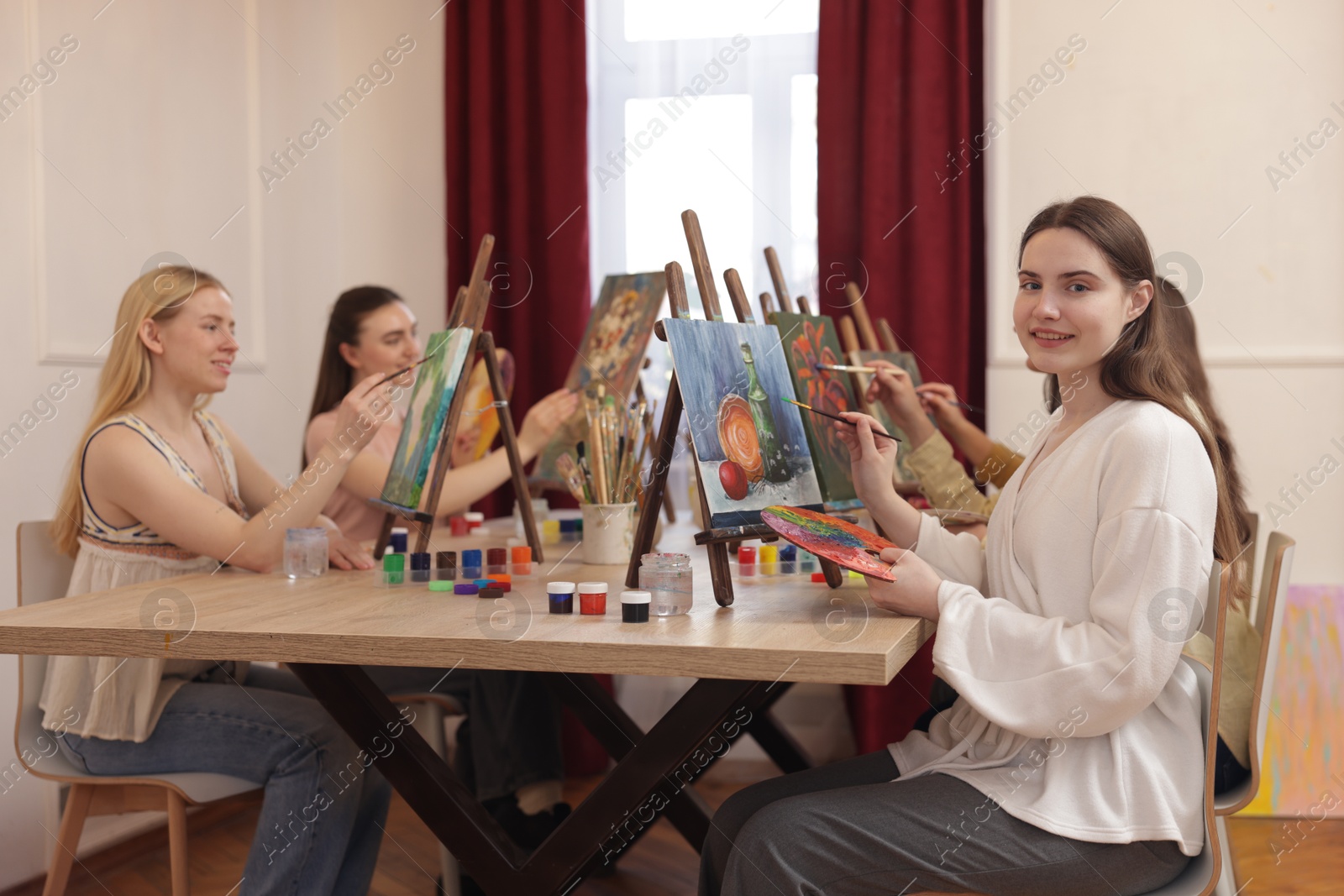 Photo of Group of women learning to draw at table in class