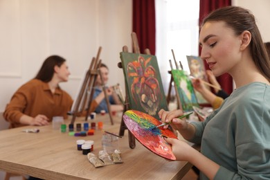 Photo of Group of women learning to draw at table in class