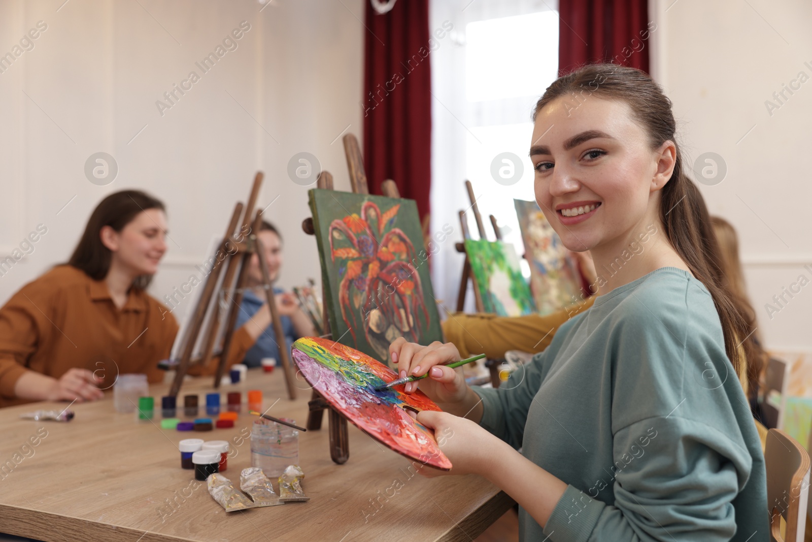 Photo of Group of women learning to draw at table in class