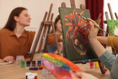 Photo of Group of women learning to draw at table in class, closeup