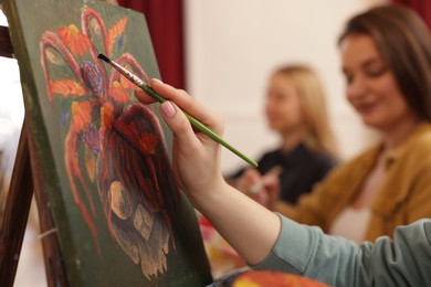 Women learning to draw in class, closeup