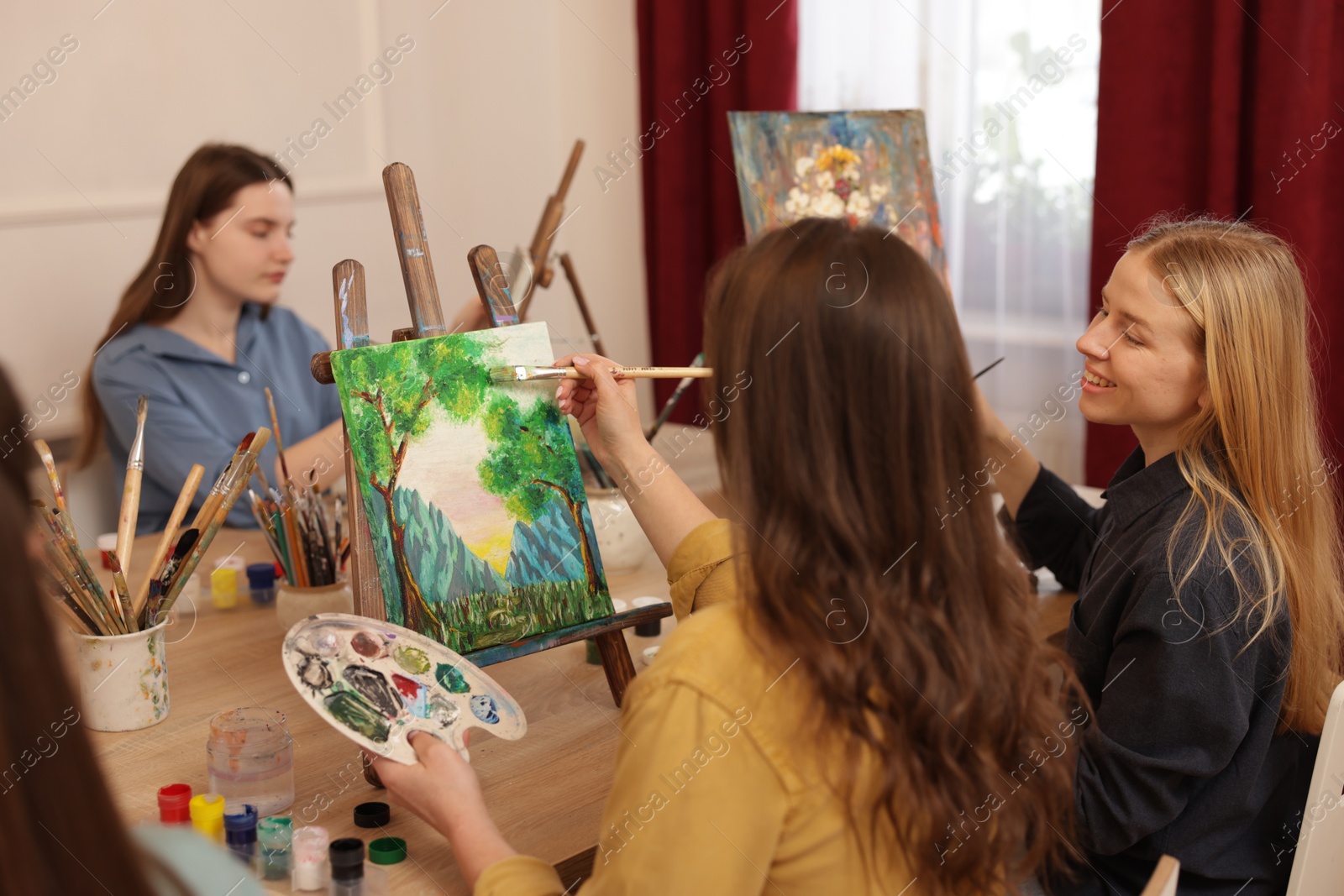 Photo of Group of women learning to draw at table in class