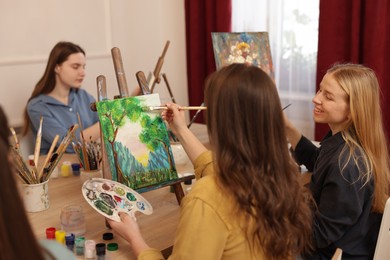 Photo of Group of women learning to draw at table in class