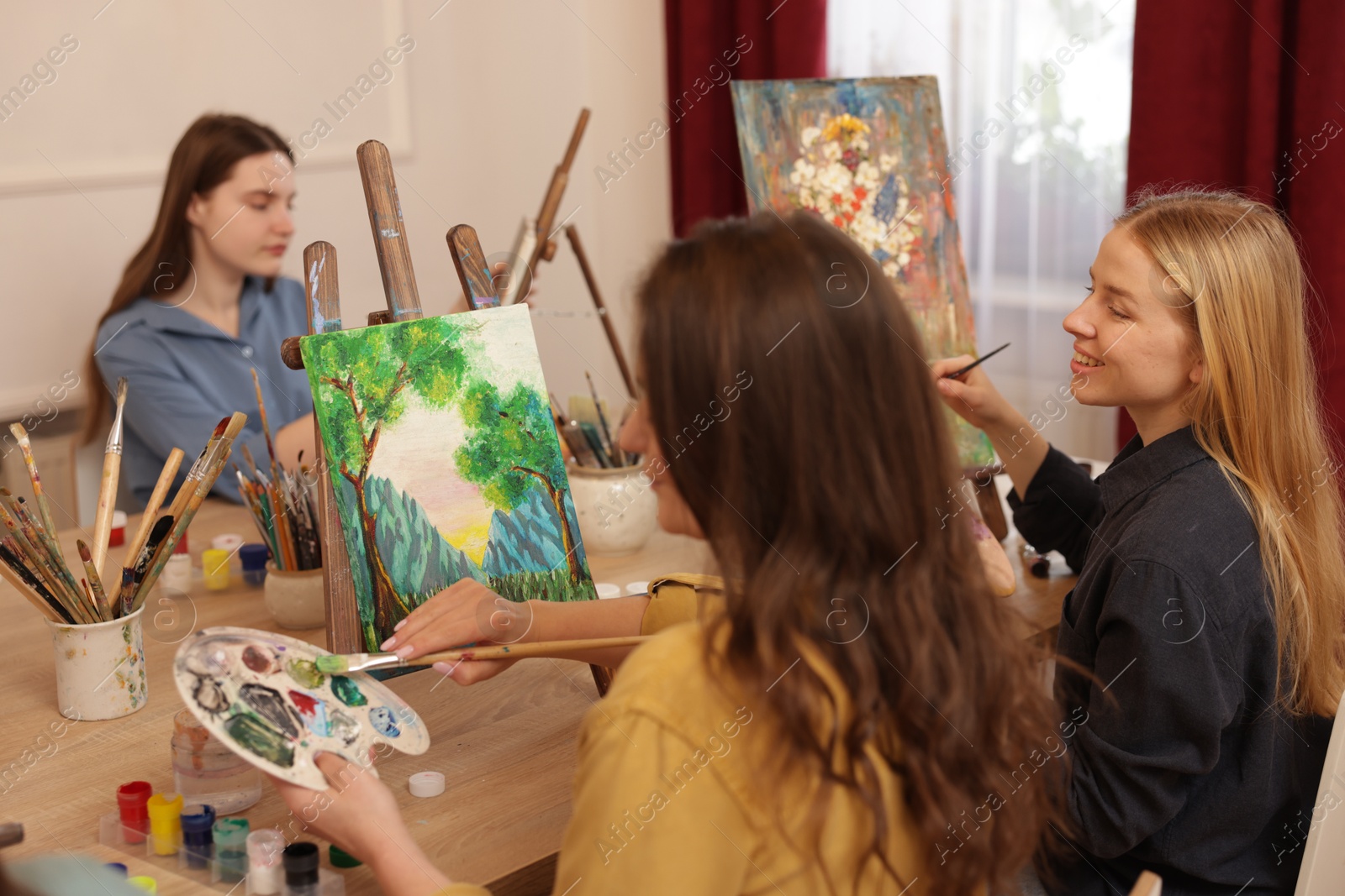 Photo of Group of women learning to draw at table in class