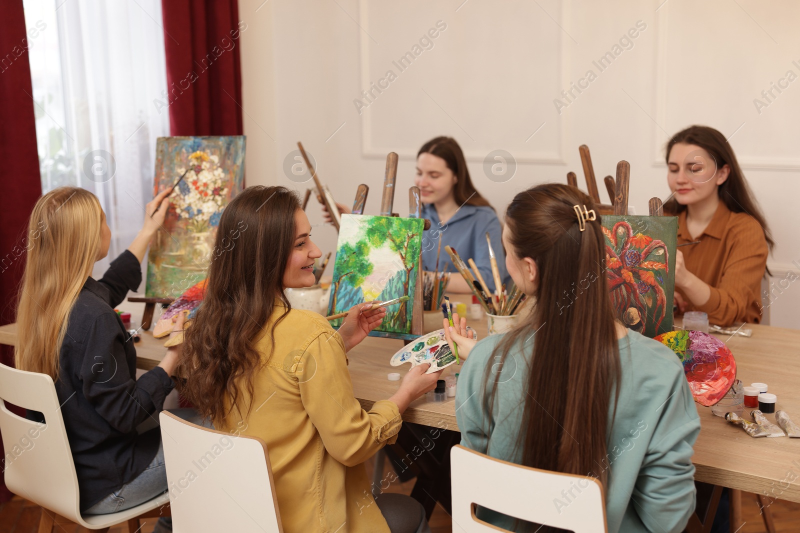 Photo of Group of women learning to draw at table in class