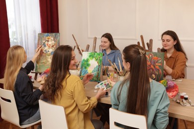 Photo of Group of women learning to draw at table in class